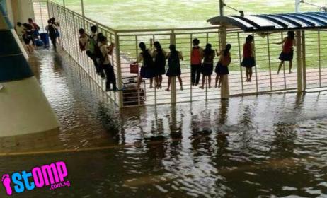 Fairfield Methodist Secondary students clinging to a fence to avoid rising flood waters.