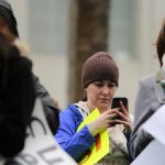Protesters post a hashtag to social media together to make it trend as they denounce policies of President Trump on Presidents Day at the Not My President’s Day Rally in Los Angeles, California