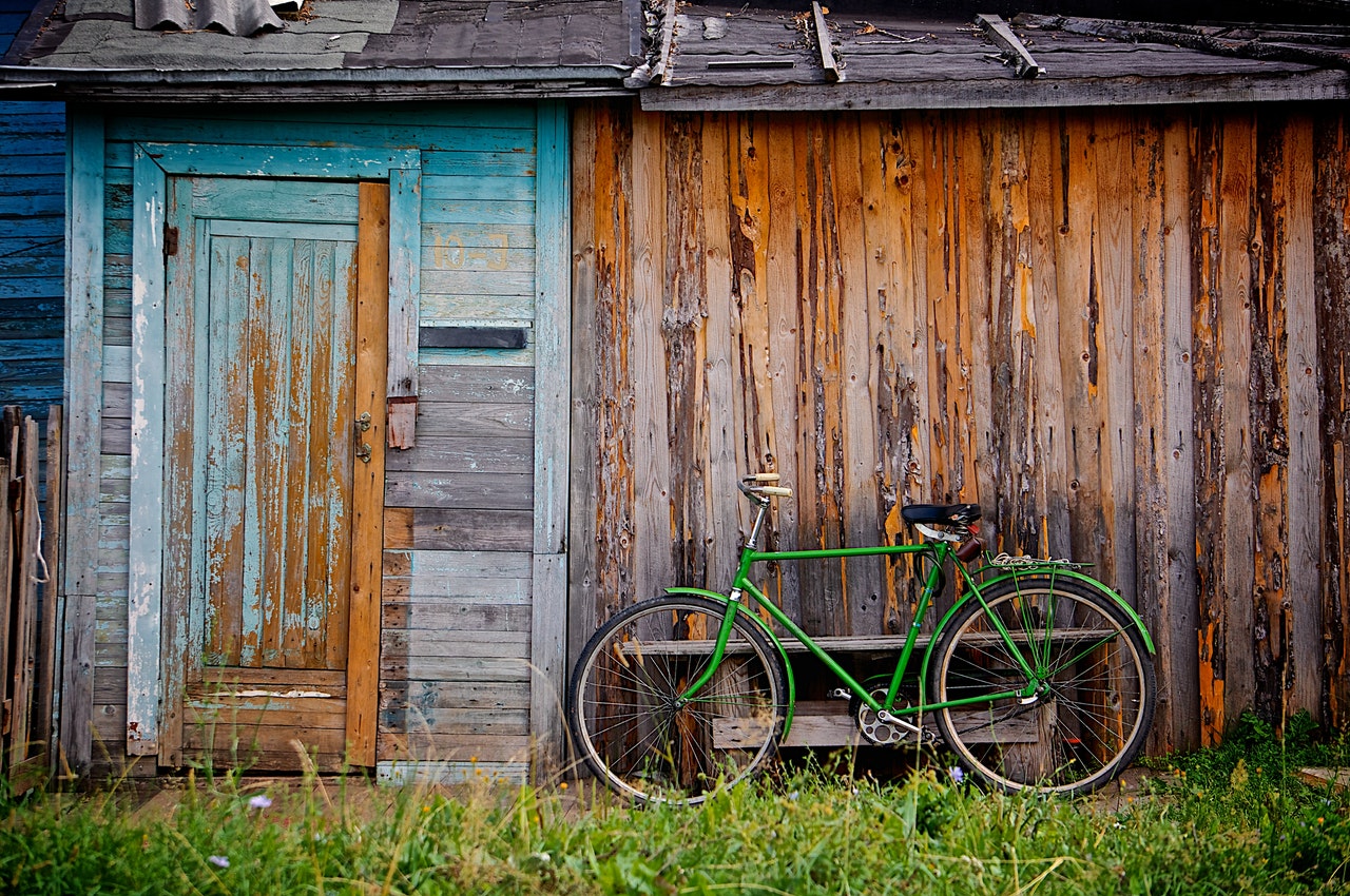 Image of a bicycle against a wall in a village