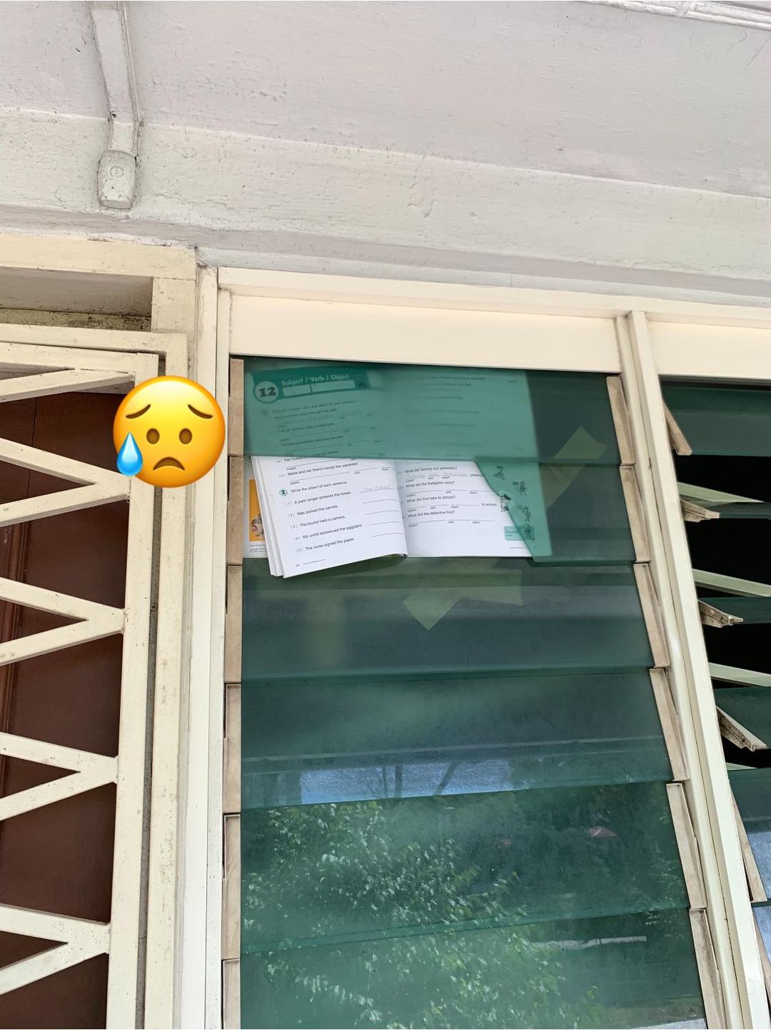 Man sees school textbook used to cover broken window glass of HDB flat; says “Poverty everywhere when you walk the low income flats in S'pore”