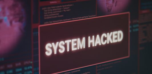 Computer monitor showing hacked system alert