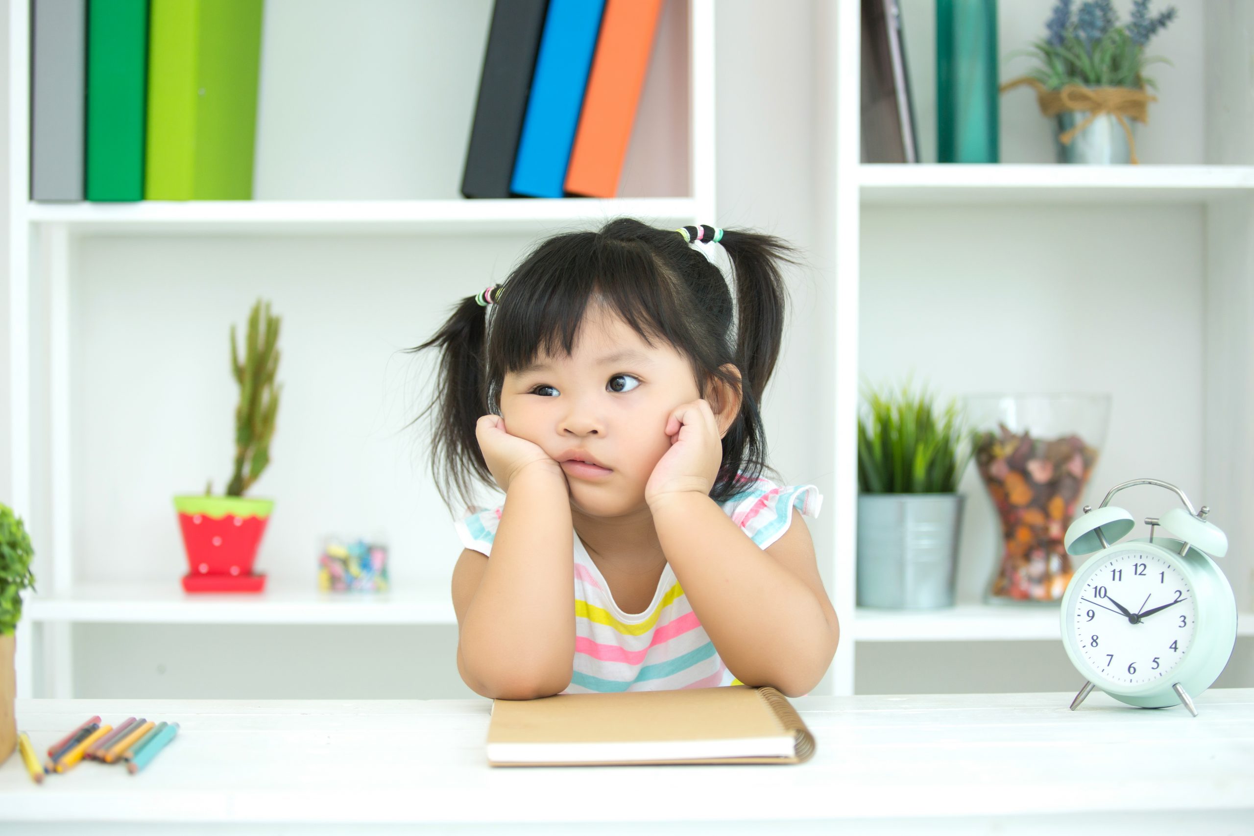 A little girl with a confused face.