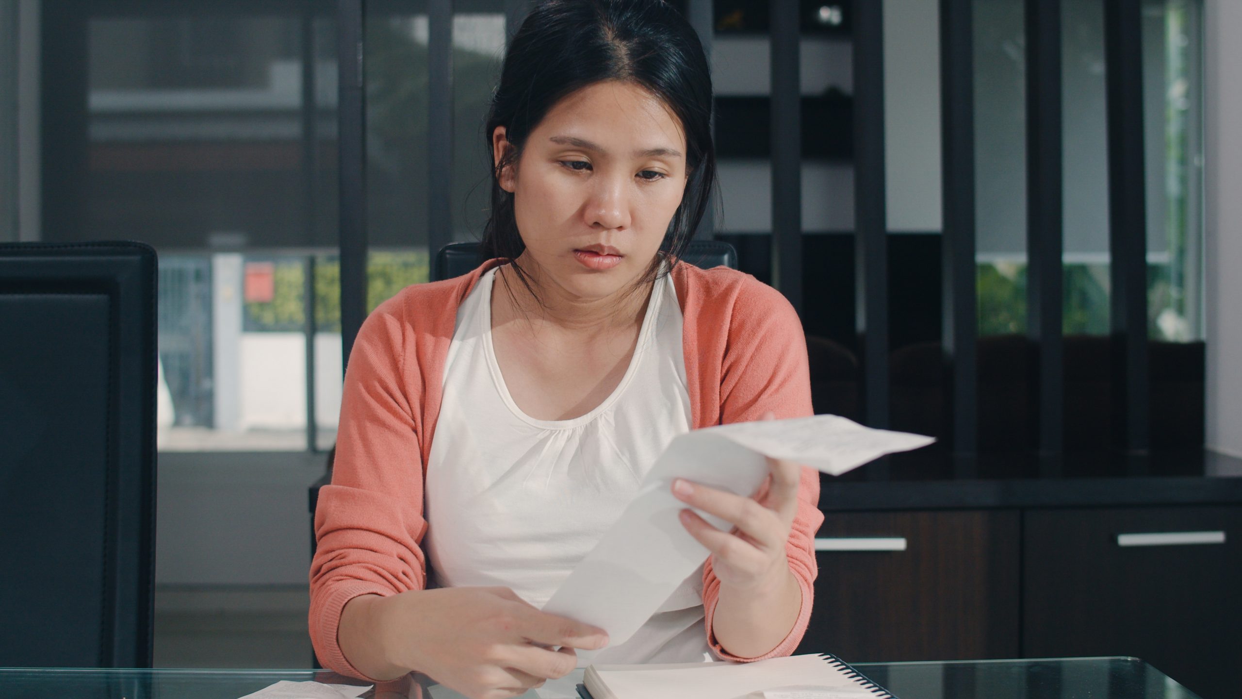 Stressed woman looking at her bills.