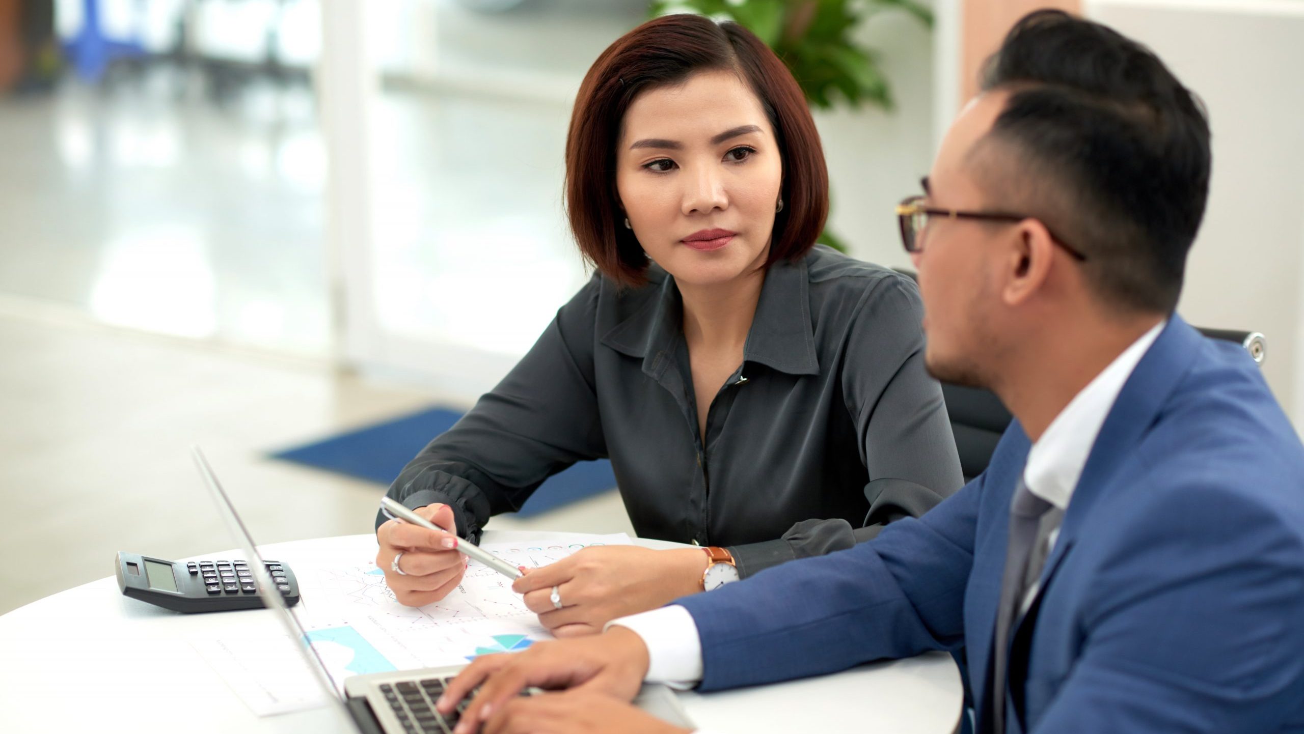 Man and woman talking at work.