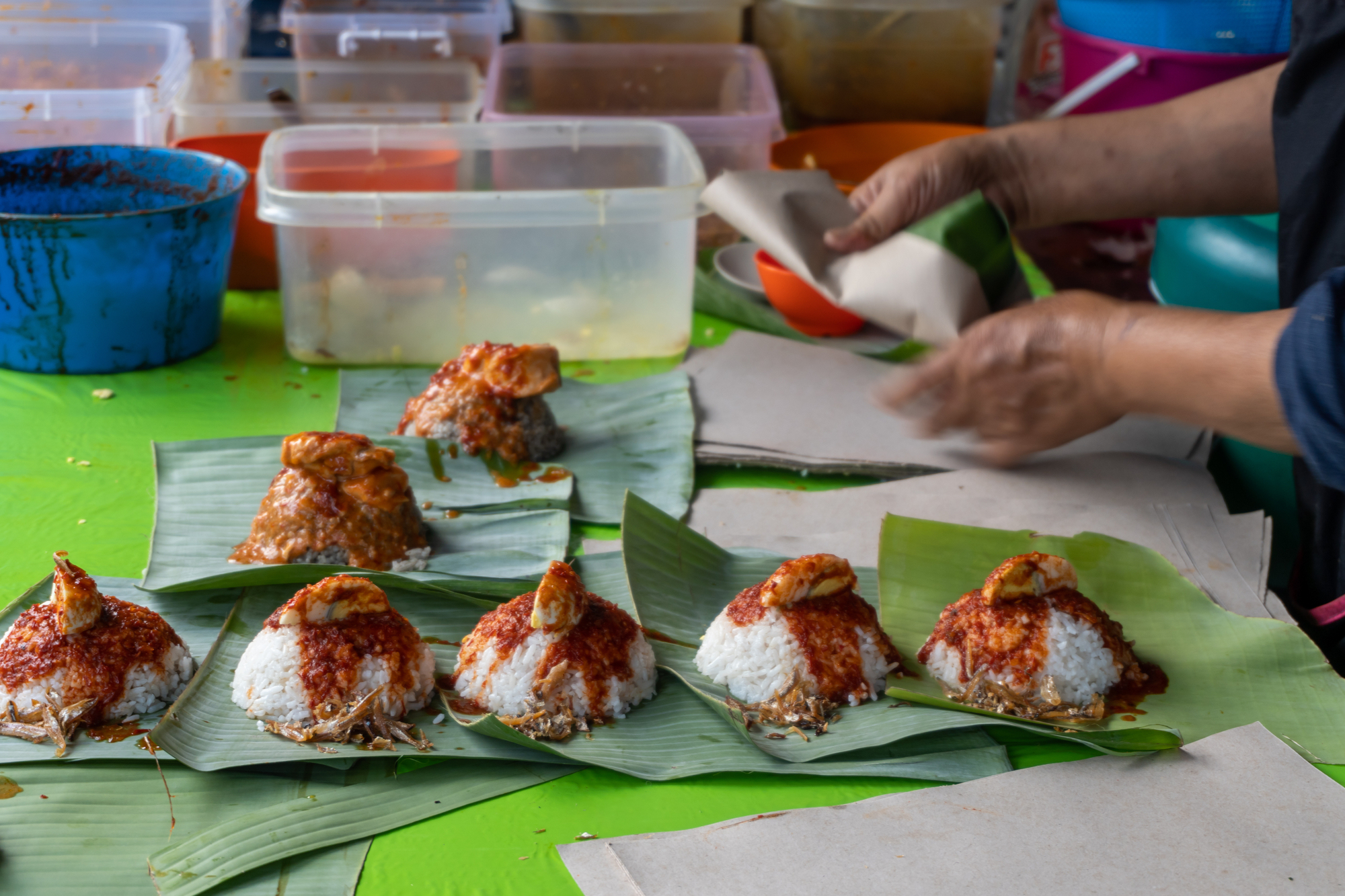 Wrapping nasi lemak with banana leave.
