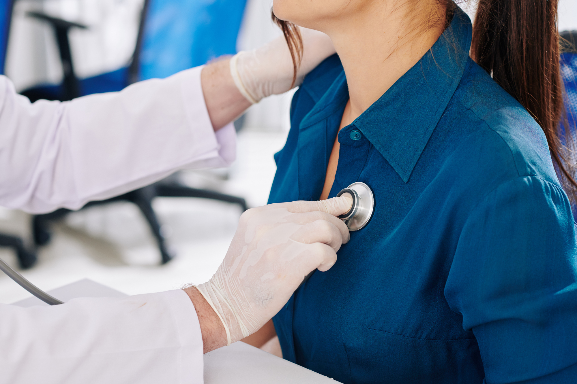 Doctor checking patient using stethoscope.