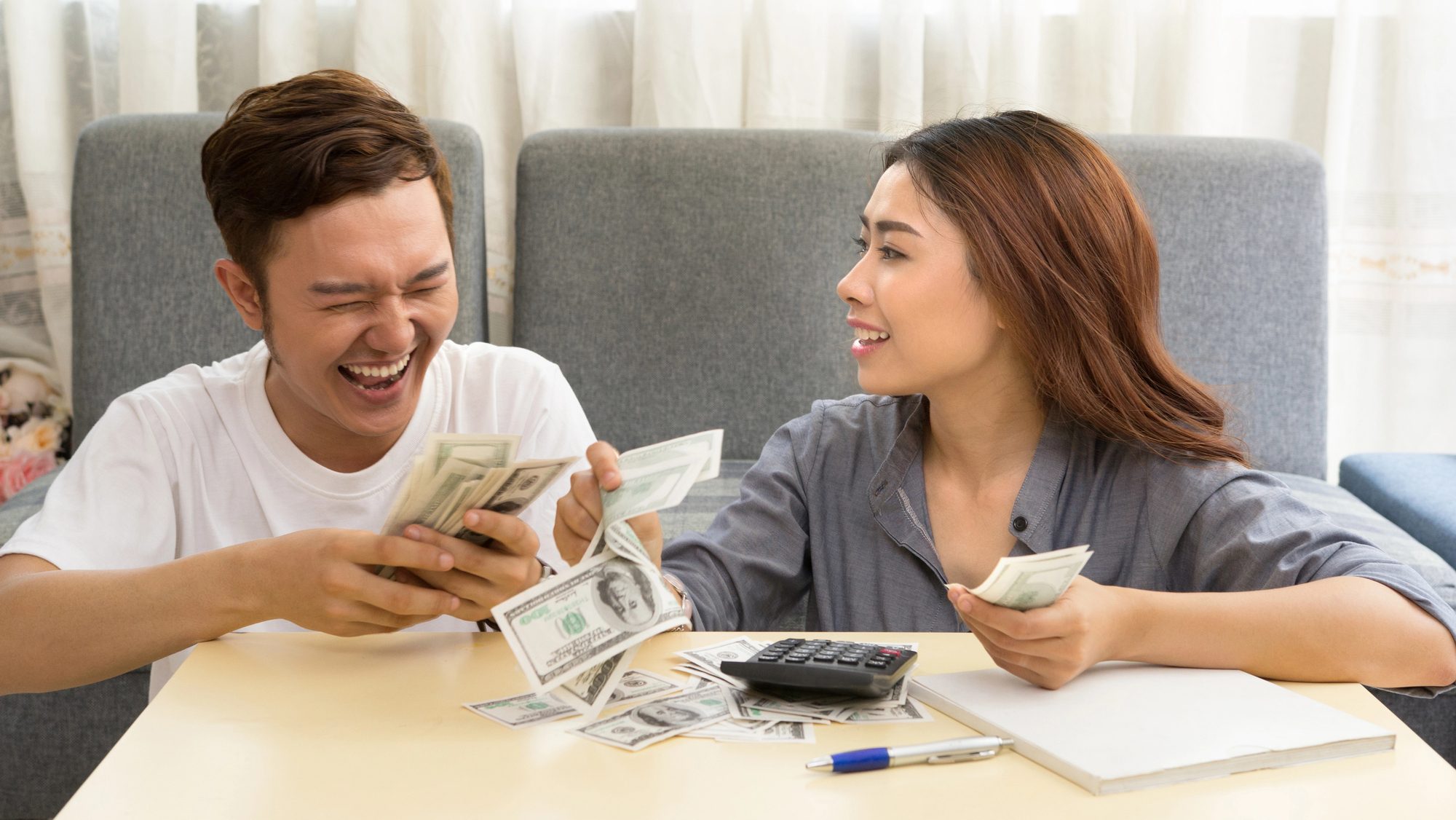 Young asian couple happy with money.