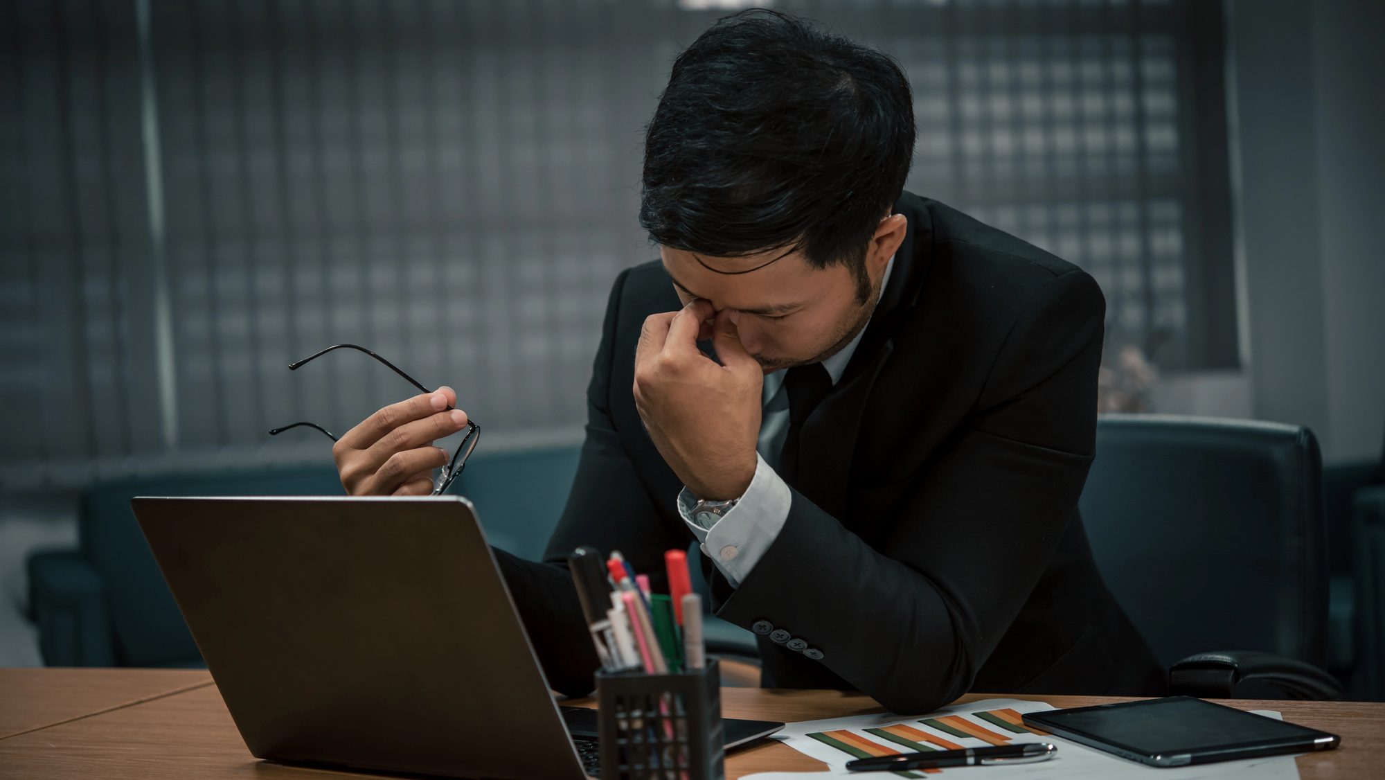 Man stressed at work in the office.