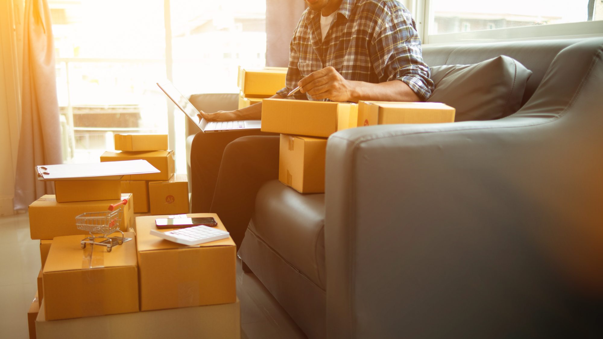 Man organising parcel boxes in the living room.