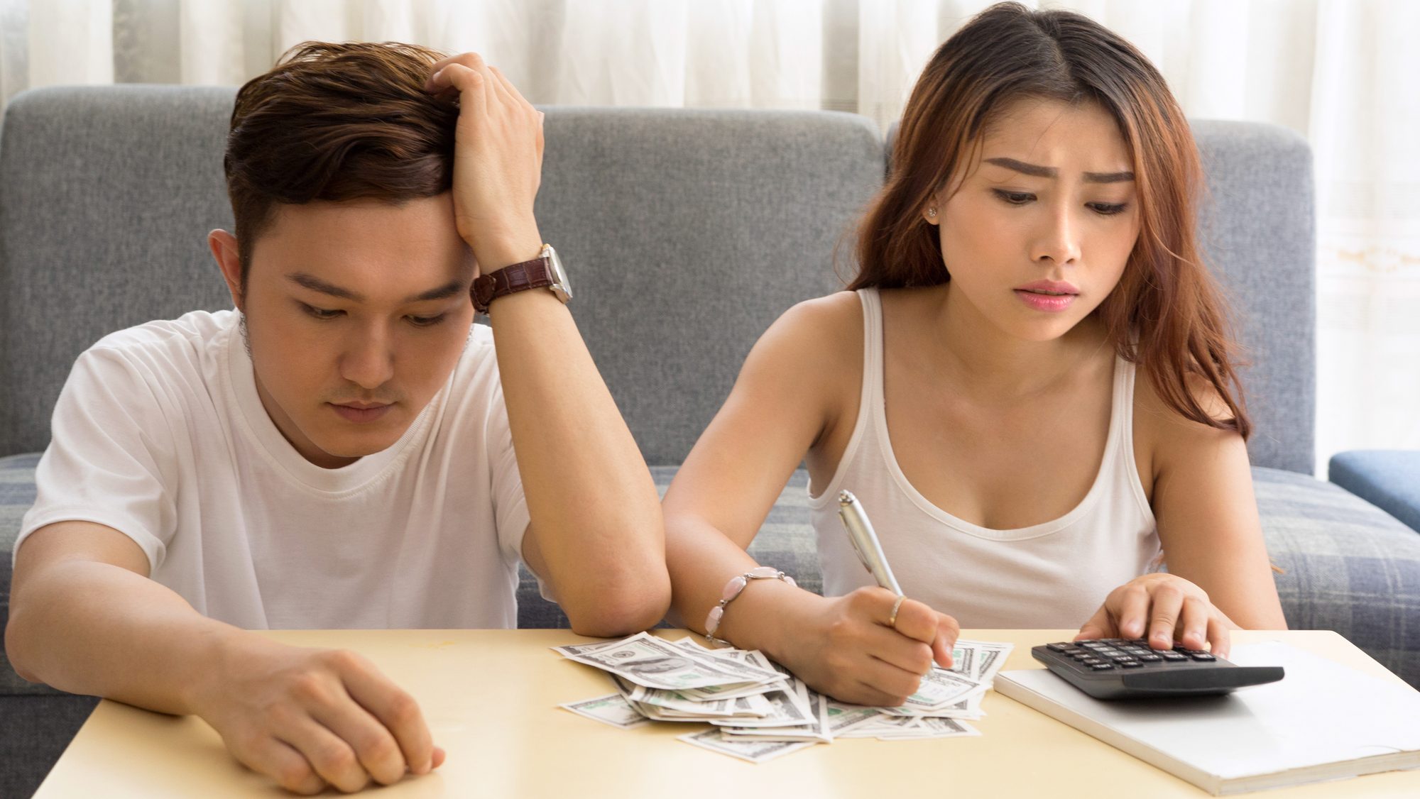 Young asian couple having money issues.