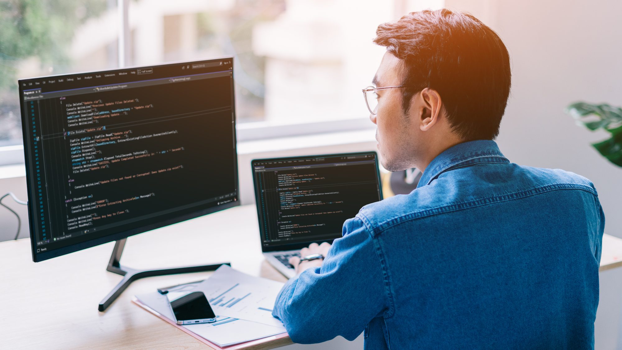 Young Asian programmer working at the office