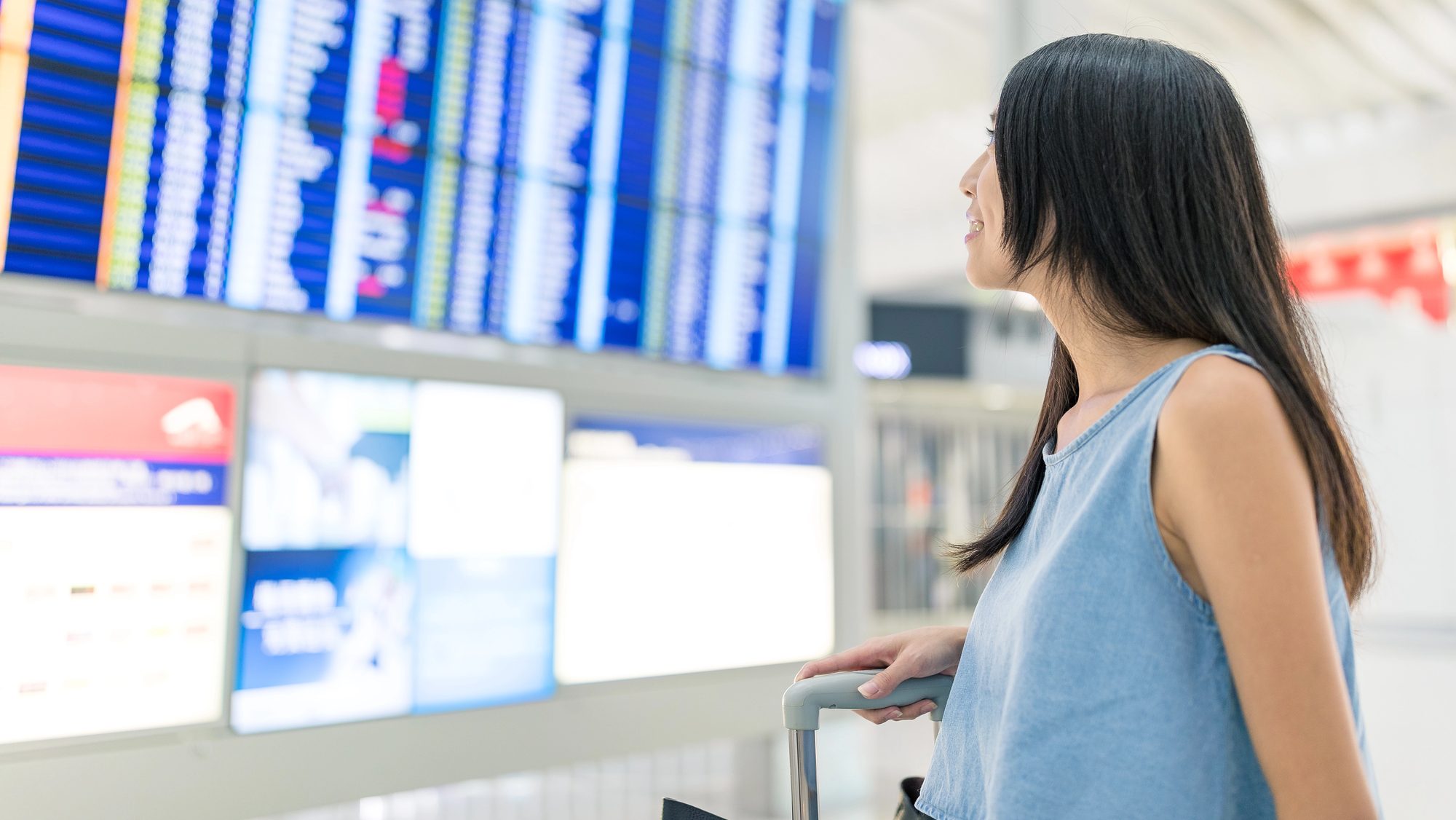 Travel woman looking at the flight number monitor