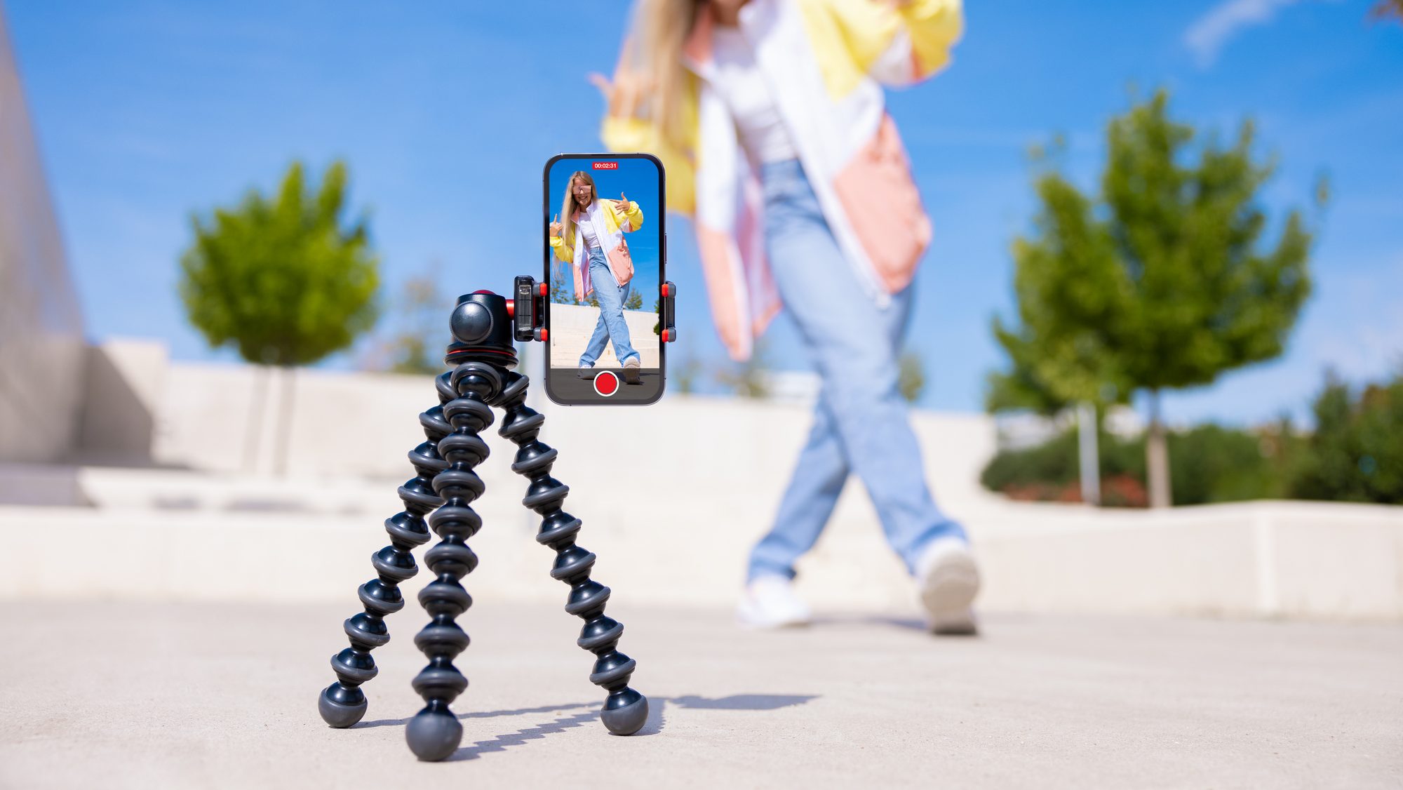 Teenage girl filming video of herself on mobile phone