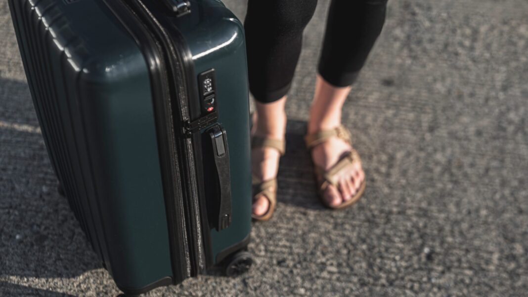 Woman holding her luggage.