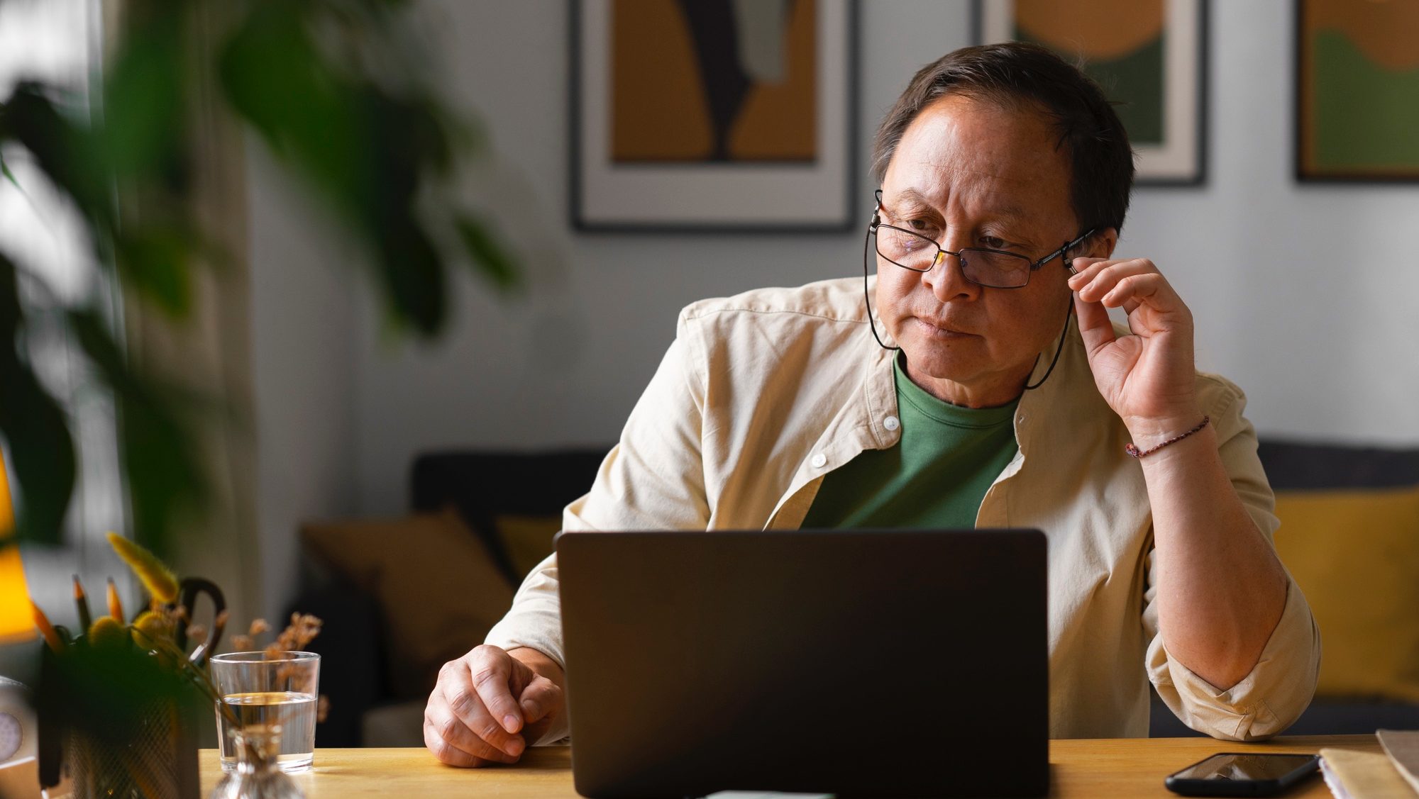 Old Asian man working using laptop