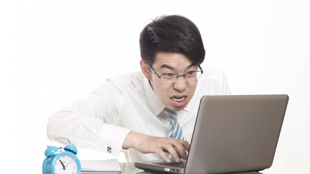 Young men working overtime in the office