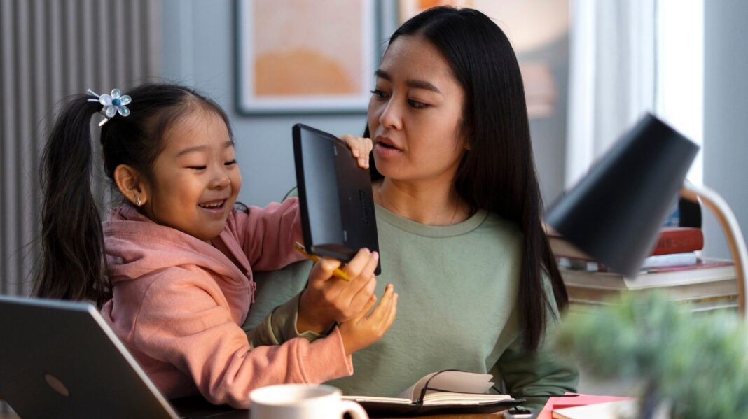 Mother working at home with daughter