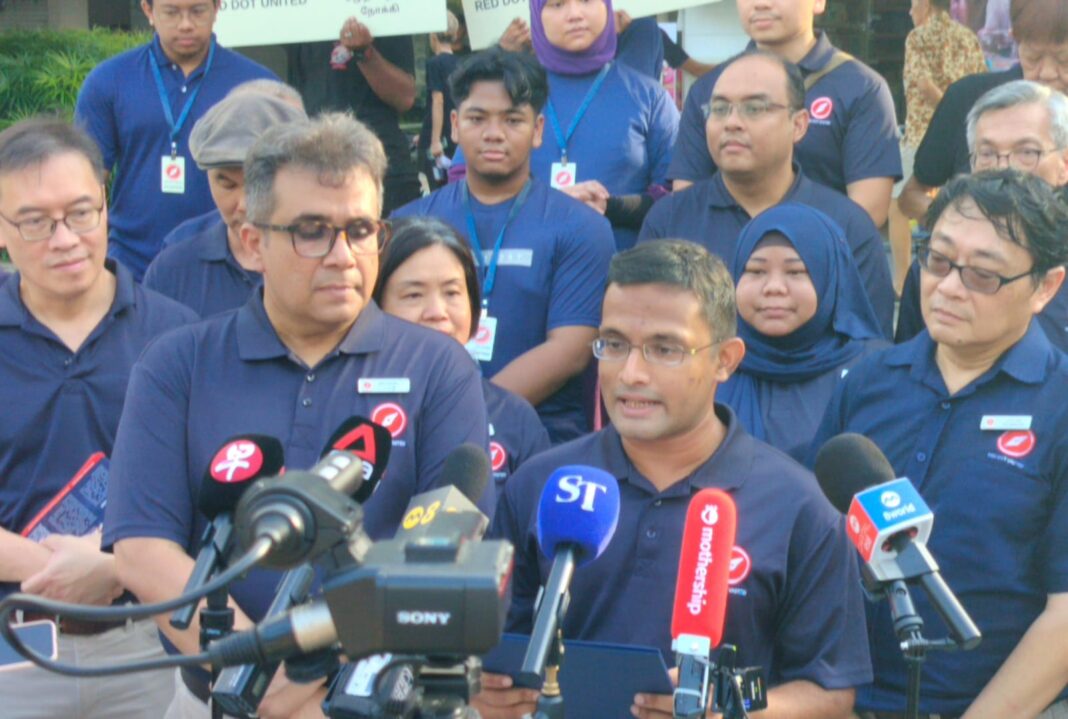 A group of people standing in front of microphones