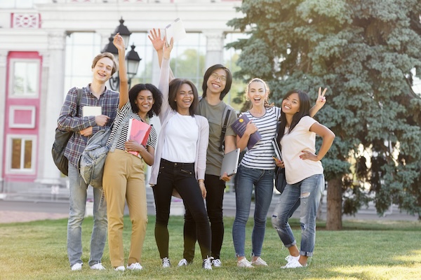 Cheerful students waving
