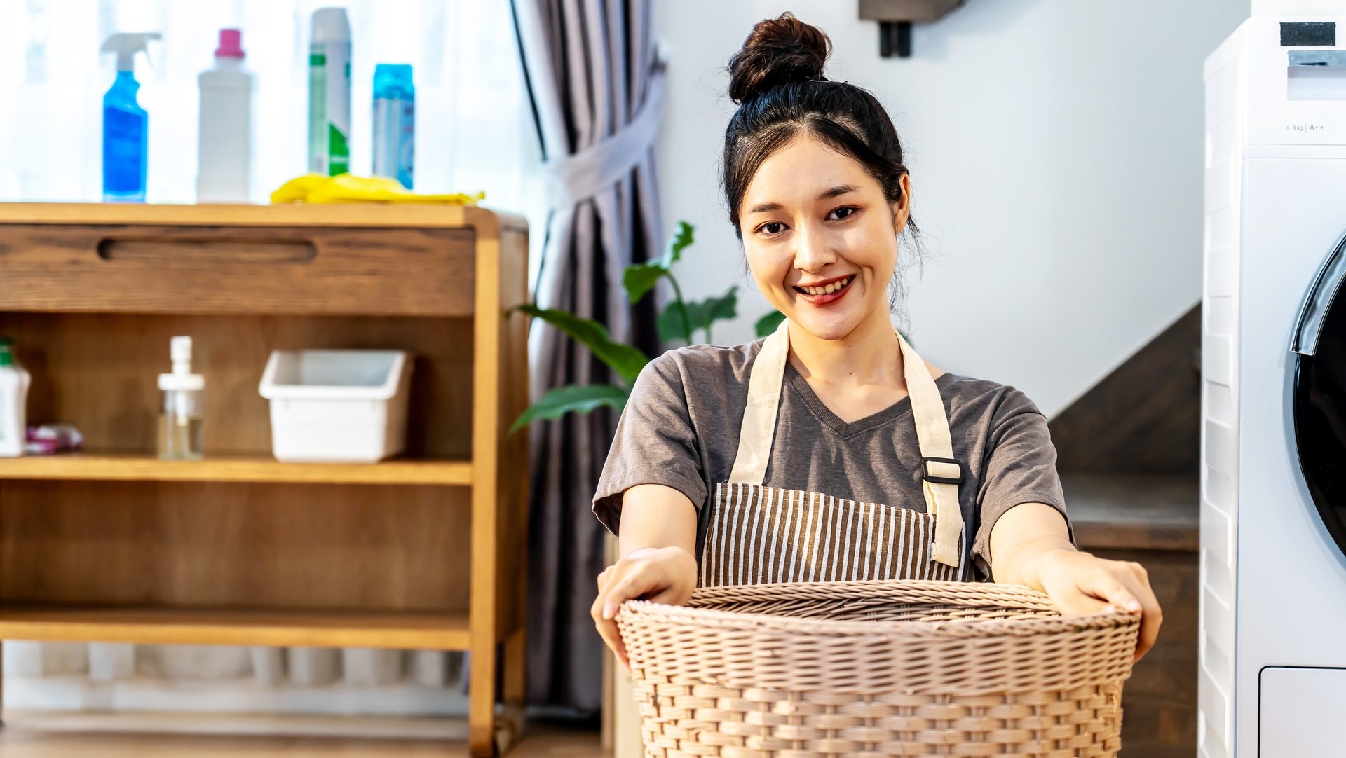 Maid guide for Singapore employers: How to talk and support your helper without drama and losing your mind (or hers) 9 medium vecteezy young asian woman sitting on floor folding clothes at 50037377 medium e1760118373726