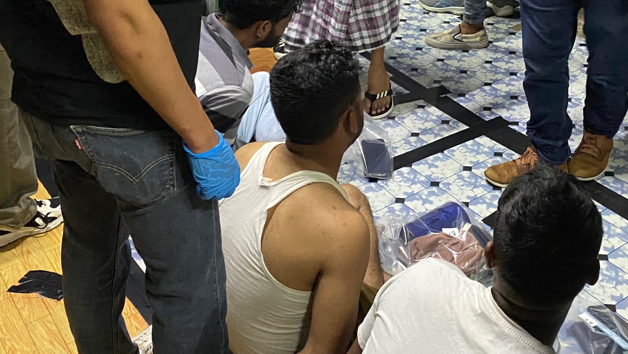Twelve migrant workers arrested in overnight CNB raid at Woodlands ...