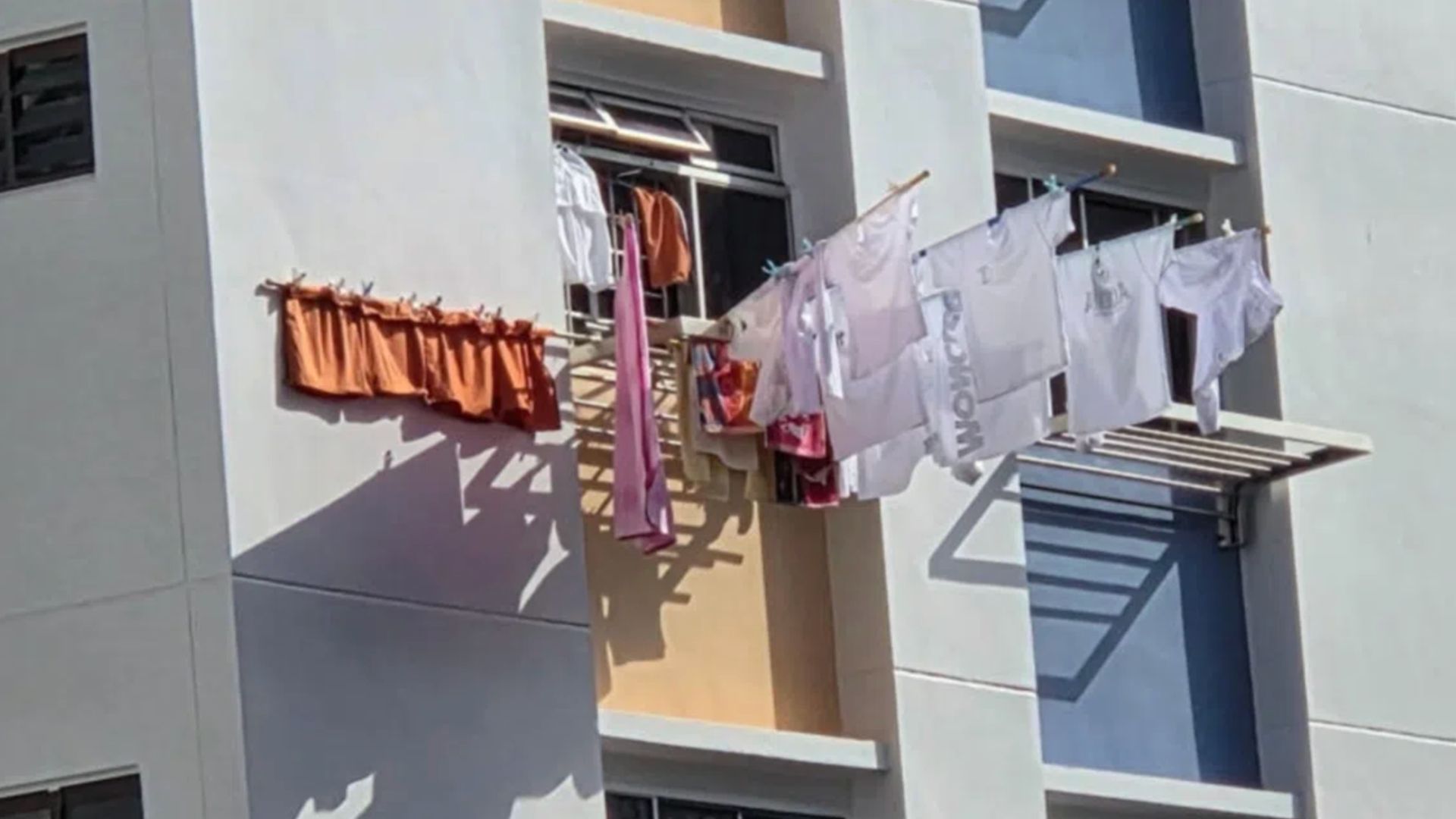 Residents complained about the dangers of bamboo poles on clothes racks outside a unit's window, elderly woman says its tightly secured