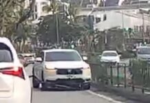 Car accidentally crashes through road guardrail and drives into the opposite lane, other vehicles swerve to not get hit