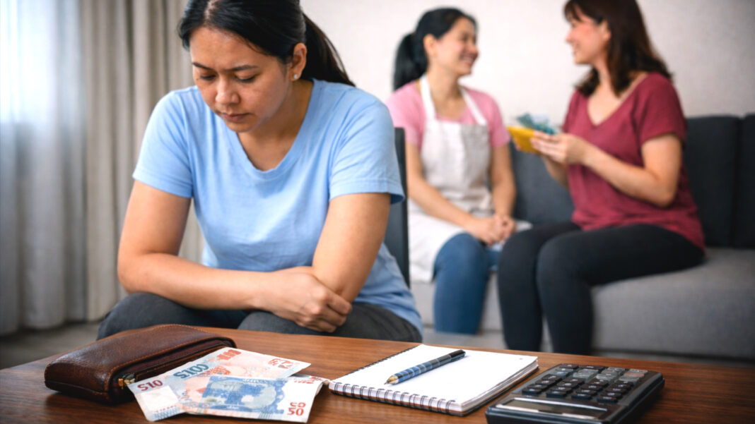 Three women sit together in a living room, with one looking down at everyday items placed on the table in front of them