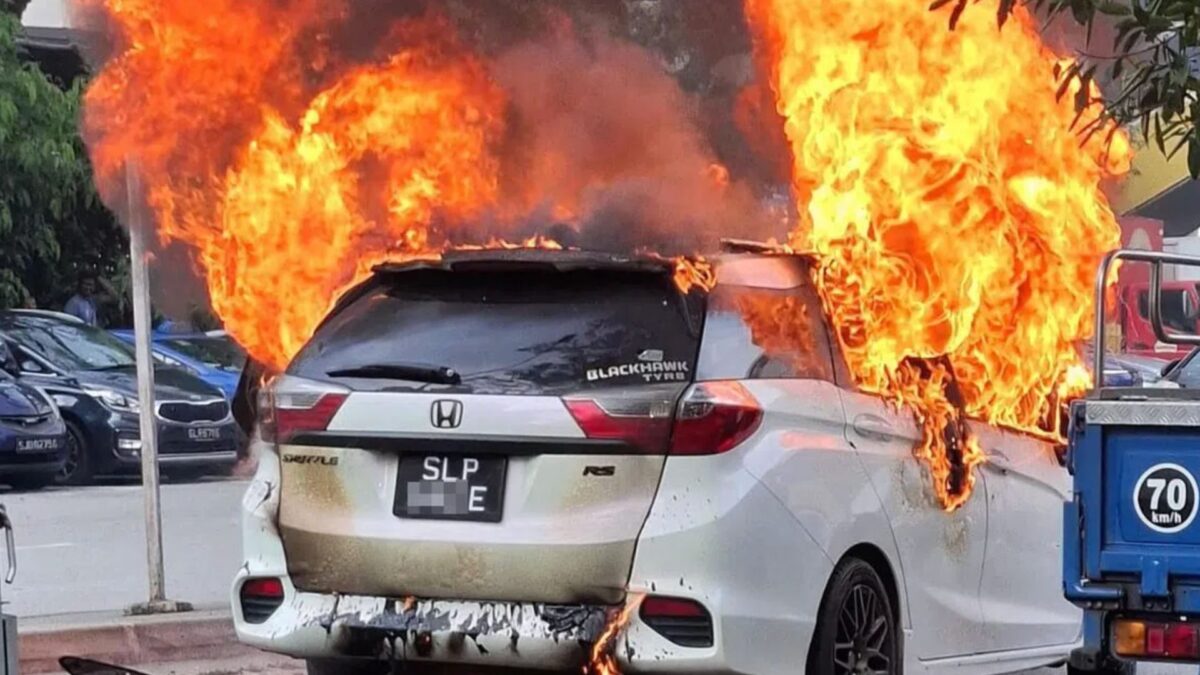 Vehicle bursts in parking lot prompting members of the public to extinguish flames